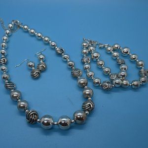 Bundle of necklaces along with one bracelet and one pair of earrings.